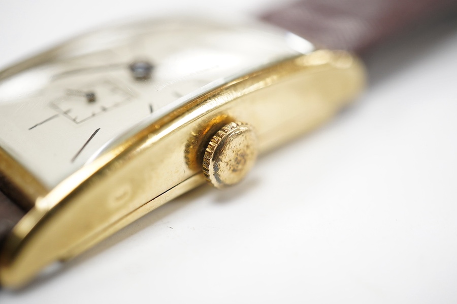 A gentleman's 14k gold Longines manual wind wrist watch, with rectangular dial, baton numerals and subsidiary seconds, case diameter 20mm, on a later associated strap. Condition - fair